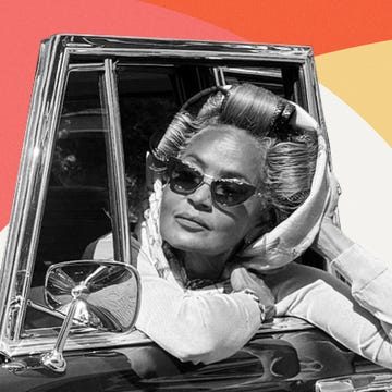 A stylish person with rolled hair and sunglasses leaning out of a vintage car against a colorful background.
