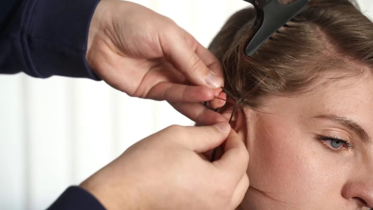 Begin the first reverse French braid close to the hairline, crossing the strands underneath so the braid stays raised.