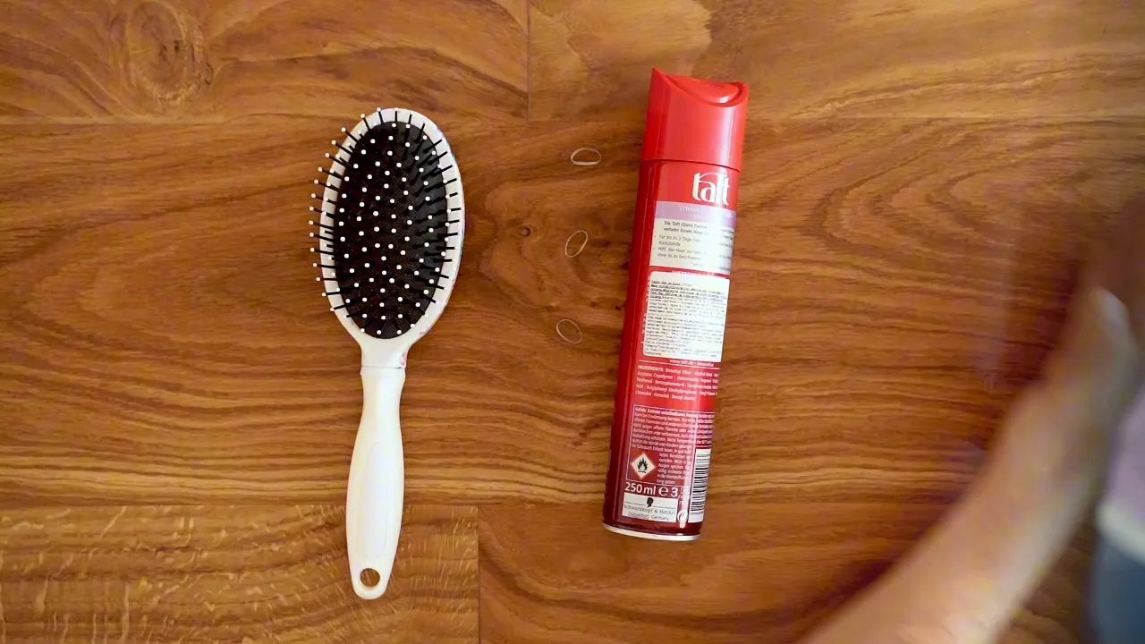 The core prep kit from the tutorial: a brush, light hold spray, clear elastics, sectioning clips, and a tail comb for neat parts.