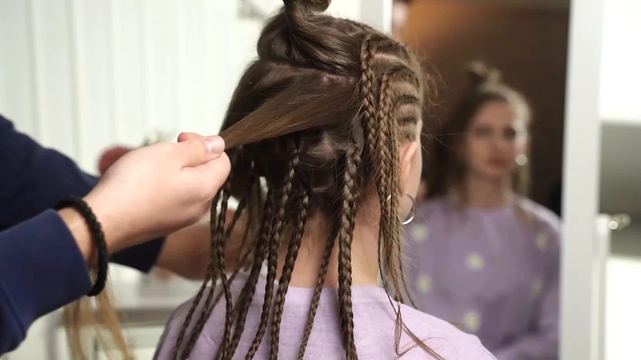 Finish the back in small sections, starting the upper back pieces as short reverse French braids for extra depth.